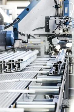 PVC windows automatic line machine cutting sections panels Stock Photos