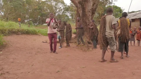 Pygmies returning from the hunt with nets carry a small antelope Stock Footage 105248634