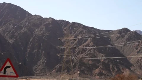 The pylon overhead power line in the desert between the mountains view from the Stock Footage 251886002
