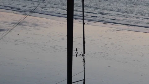Pylon stands majestically over a sunset reflected beach Video stock 85739346