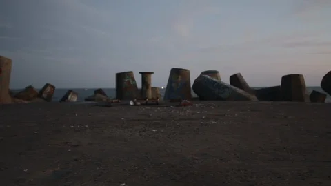 Pylons on Beach with Dolly Movement Stock Footage 128250525