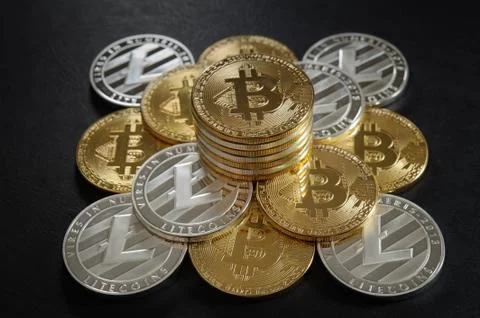 Pyramid from bitcoins and litecoins with stack of coins on the top 스톡 사진