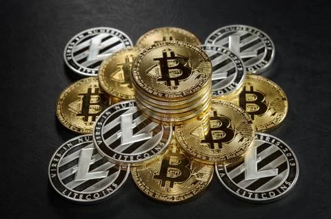Pyramid from bitcoins and litecoins with stack of coins on the top. 스톡 사진