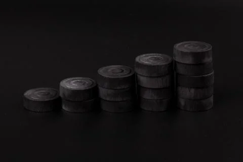 Pyramid of black chips backgammon for playing backgammon on black background. 写真素材