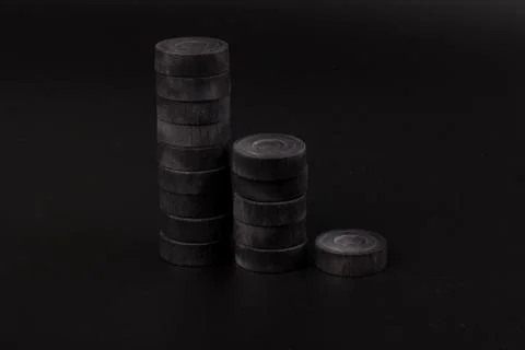 Pyramid of black chips backgammon for playing backgammon on black background. 写真素材