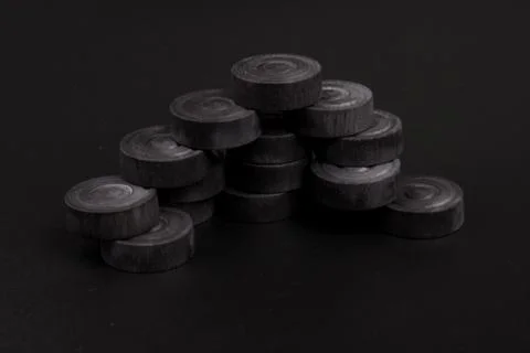 Pyramid of black chips backgammon for playing backgammon on black background. 写真素材