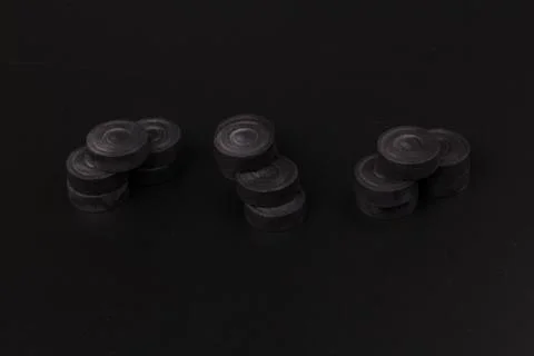 Pyramid of black chips backgammon for playing backgammon on black background. 写真素材