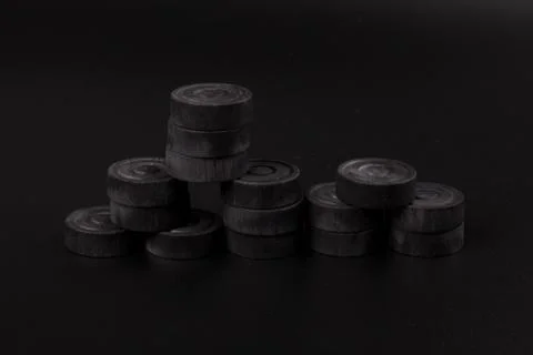 Pyramid of black chips backgammon for playing backgammon on black background. 写真素材
