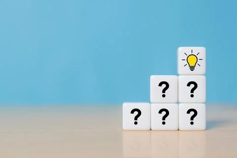 Pyramid of dice or cubes with question mark symbol icons stacked on wooden .. Stock Photos