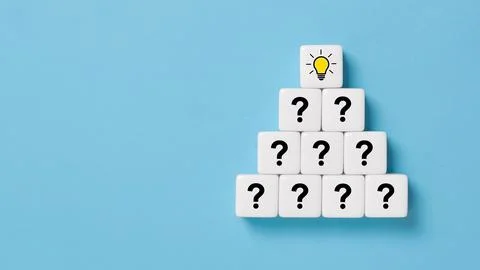 Pyramid of dice or cubes with question mark symbol icons stacked on wooden .. Stock Photos