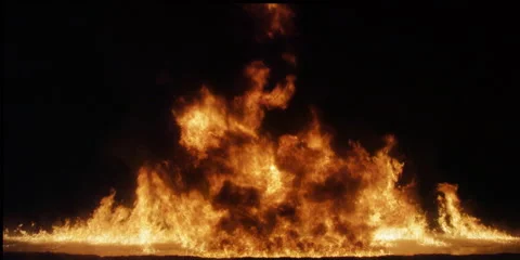 A pyramid of flame in center frame gradually burns down Stock Footage 59122688