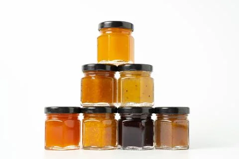 Pyramid of jams. Different jam jars in piramid. Jam set. Different jam flavor 写真素材