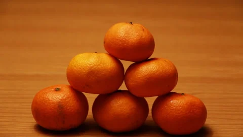The pyramid is made of Mandarin slowly begins to fall Stock Footage 86090246