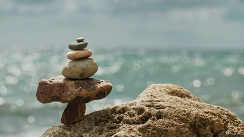 A pyramid of rocks against a blurred background of the sea, bokeh, you can see Stock Footage 218404887