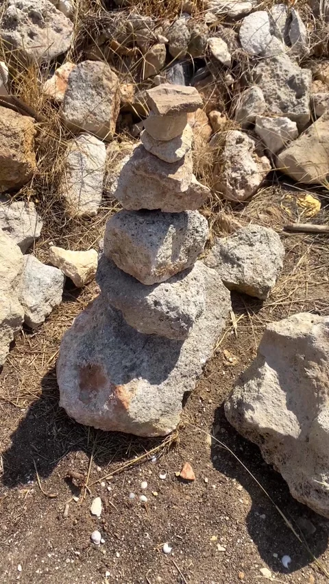 Pyramid of rocks. Stones of different sizes. Vertical video Stock Footage 286233767