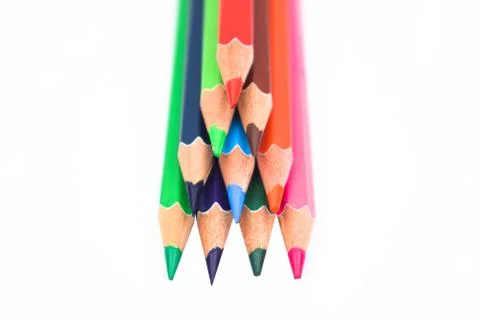 Pyramid shape made with some different colored wood pencil crayons on a white Stock Photos