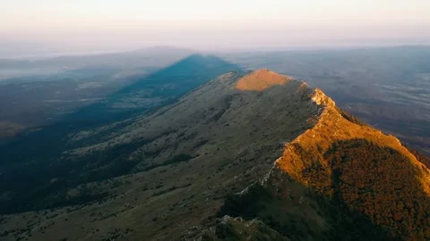 Pyramid shape shade of Rtanj mountain peak on sunrise Stock Footage 247968160