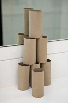 A pyramid shaped stack of empty toilet paper rolls Foto stock