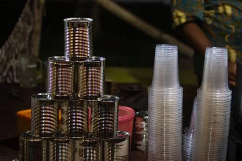 Pyramid Stack of Empty Tin Cans and Plastic Cups at Indonesian Drink Stall .. Stock Photos