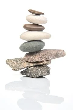 Pyramid of stacked stones on a white background. stabilization and balance .. Stock Photos