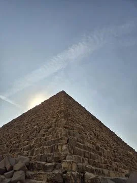 Pyramid stone blocks close-up from low angle with the apex against a blue s.. Stock Photos