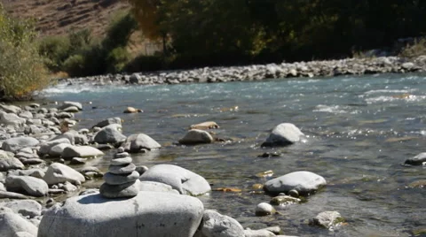 Pyramid of stones on a background of the river Stock Footage 49025198