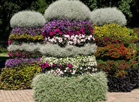 Pyramidal flower beds decorated with multi-colored petunias and other flowers Stock Photos