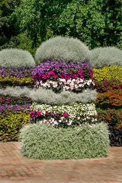 Pyramidal flower beds decorated with multi-colored petunias and other flowers Stock Photos