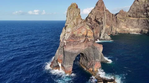 Pyramidal sea stack and arch of Ilhéu da Pocariça off the coast of Madeira Stock Footage 311898777