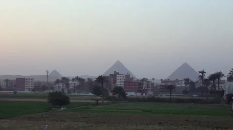 The pyramids of Egypt are seen in the distance behind the Cairo skyline. Stock Footage 41668694