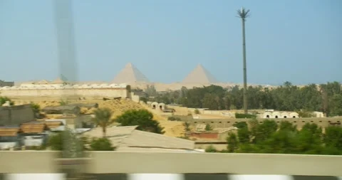 Pyramids of Giza view from the window of a moving car Stock Footage 288243752