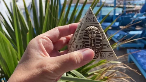 Pyramids in hand on the palms and blue sky background, tourism in Egypt concept, Video stock 277524903