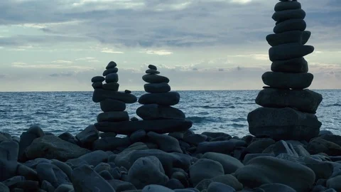 Pyramids of stones on a pebble beach Stock Footage 81400737