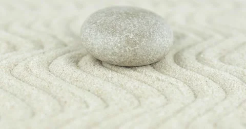 Pyramids of white and gray zen stones on sand with abstract wave drawings. Stock Footage 152889573
