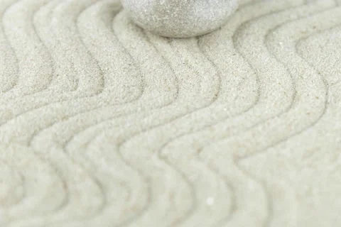 Pyramids of white and gray zen stones on sand with abstract wave drawings Stock Footage 152889575