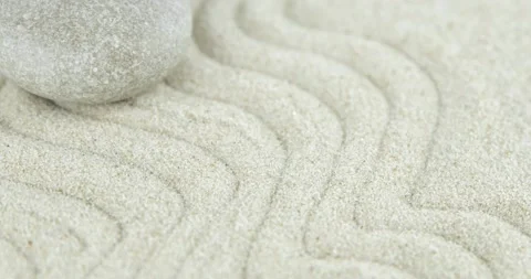 Pyramids of white and gray zen stones on sand with abstract wave drawings Stock Footage 152889583