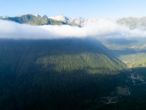 Pyrenees mountains with clouds covering forested valley Stock Photos