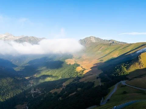 Pyrenees mountains landscape with clouds and winding road Stock Photos