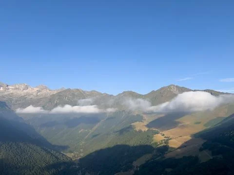 Pyrenees mountains valley with rolling clouds and blue sky Stock Photos