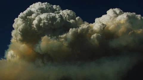 Pyrocumulus clouds menace the deceptively calm blue sky. Stock Footage 326939852