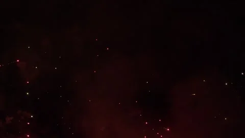 Pyrotechnic fireworks explode into red sphere in dark night sky 動画素材 339857681