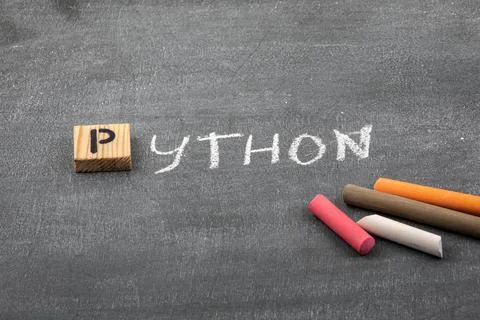 Python code and programming language concept. Colored chalk pieces on a black Stockfoto's