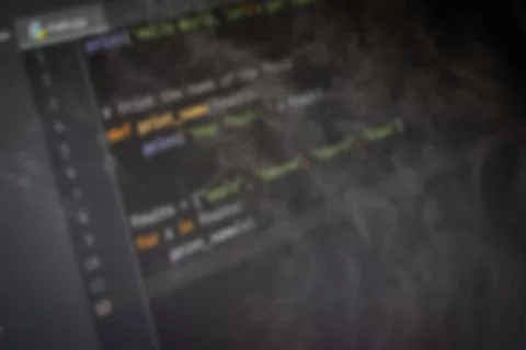 Python code on screen blurry background image 스톡 사진