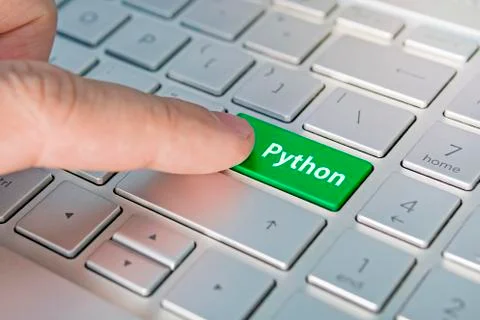 Python computer language. writing on button modern of gray laptop. Finger pre Stock Photos
