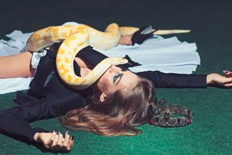 Python crawl on woman with long hair. Sensual woman with snake. Woman with 스톡 사진