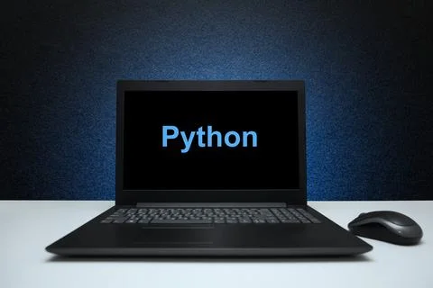 Python text on laptop screen on textured black background with blue light. Stockfoto's