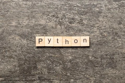Python word written on wood block. python text on table, concept 写真素材