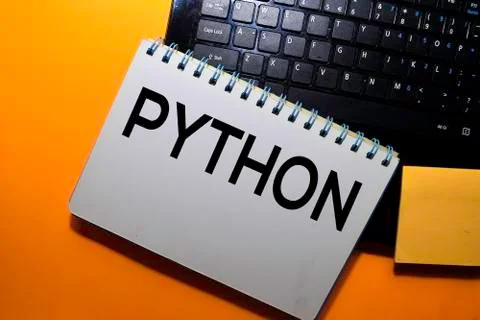 Python write on book with laptop keyboard background 库存照片
