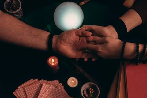 Pythoness reading the future in the hand of a man. Stock Photos