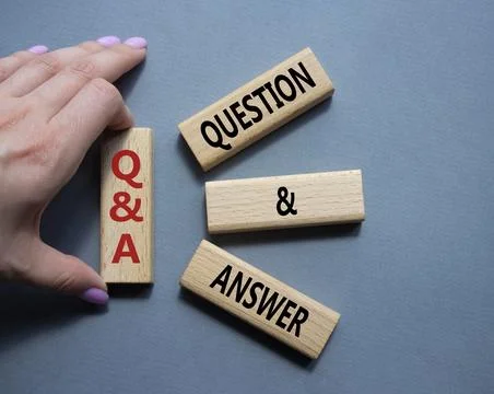 Q and A - Question and Answer. Wooden cubes with words Q and A. Businessman.. Stock Photos
